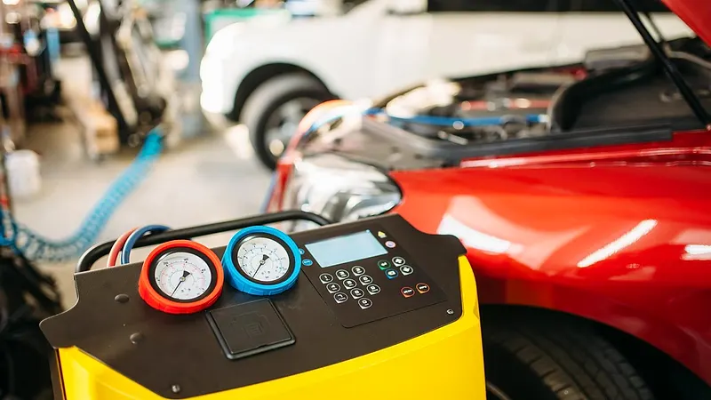 Car air conditioning re-gas machine connected to a vehicle Raimondi Auto Services Old Woking