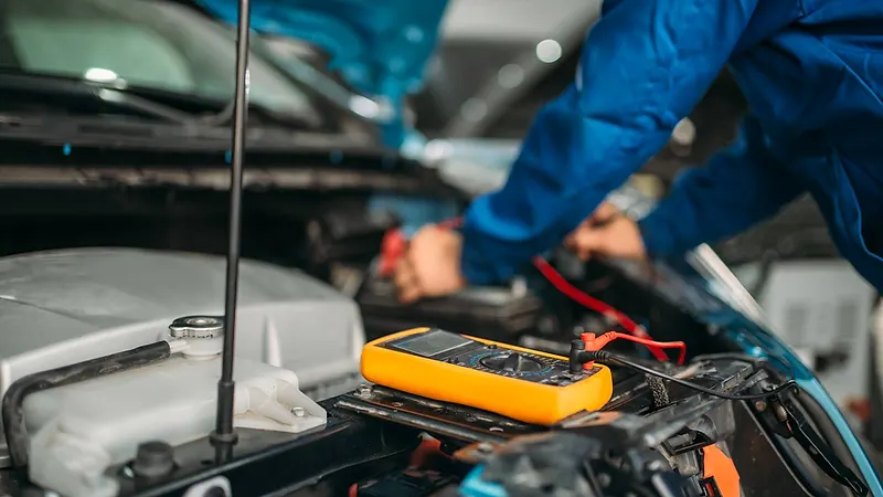 Car electrician checking battery level Raimondi Auto Services Old Woking