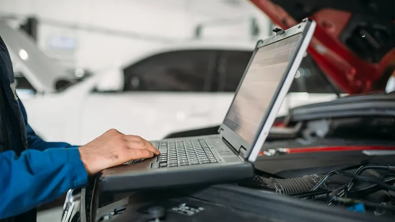 Mechanic running computer diagnostics on a car Raimondi Auto Services Old Woking