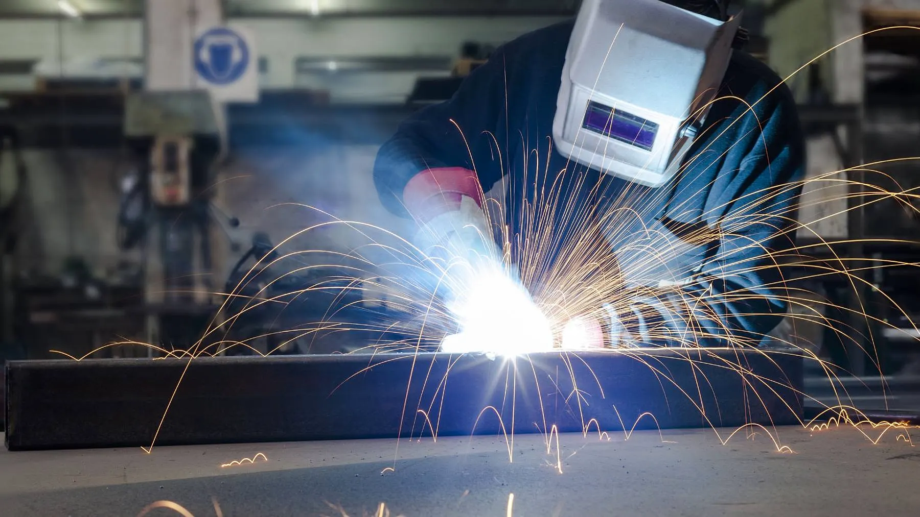Welder at work with sparks flying Raimondi Auto Services Old Woking